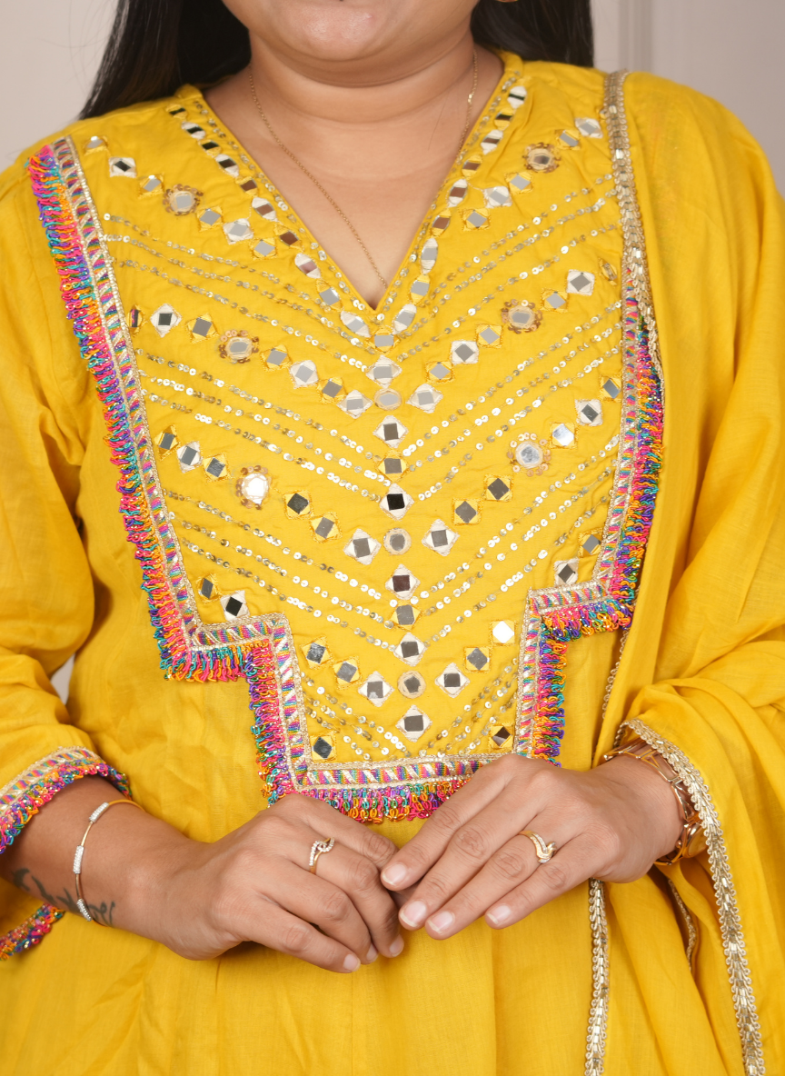 Yellow anarkali mulcotton dress with mirrorwork detaling on neck